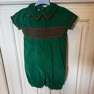 Corduroy green/red smocked jumper. Brand and size tag has been cut out. 3-6 mths
